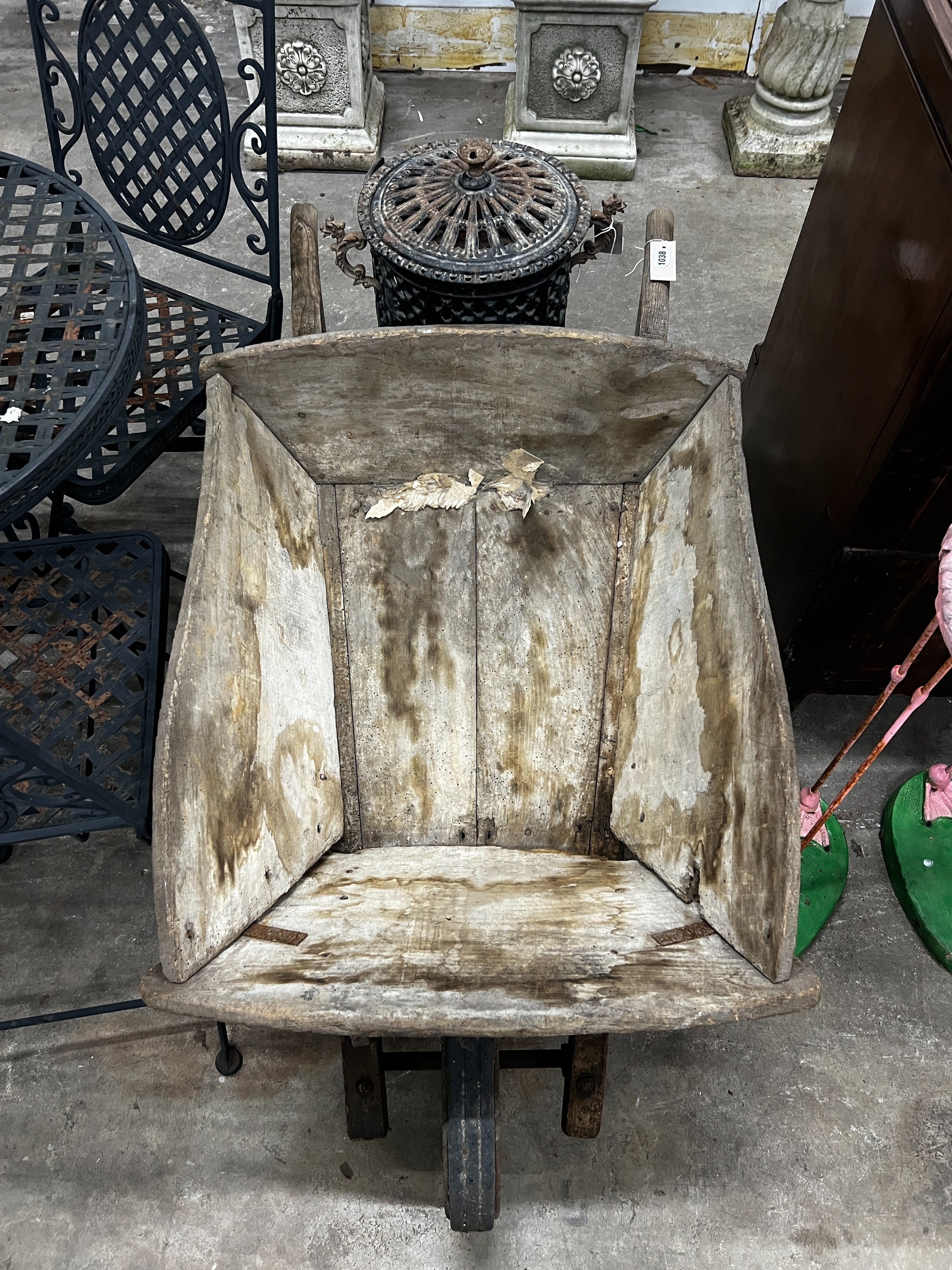 A rustic wooden wheelbarrow, width 60cm, length 110cm, height 53cm